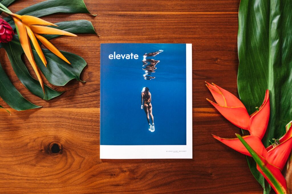 a book on a table with flowers and leaves / Photo by NMG Network on Unsplash