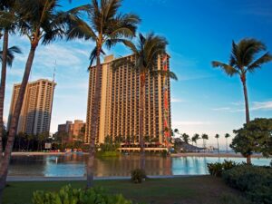 a large hotel with palm trees in front of it / Photo by Alisa Matthews on Unsplash