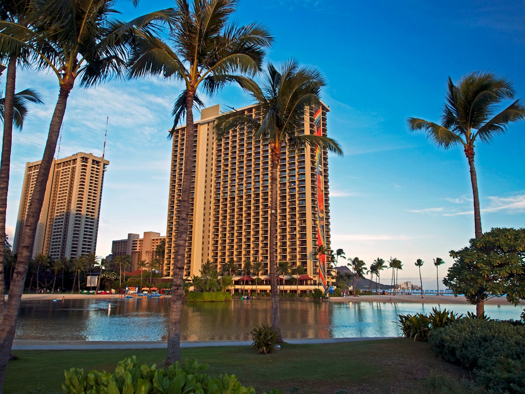 a large hotel with palm trees in front of it / Photo by Alisa Matthews on Unsplash