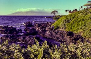 a view of the ocean with a mountain in the background