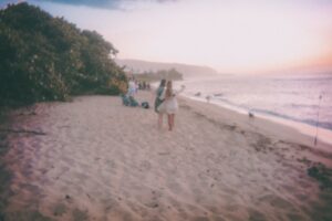 Couple walking on a beach at sunset / Photo by Devin Avery on Unsplash