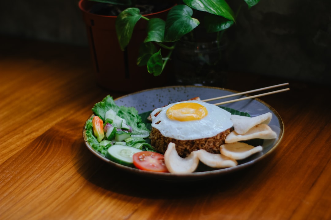 a plate of food with an egg on top of it