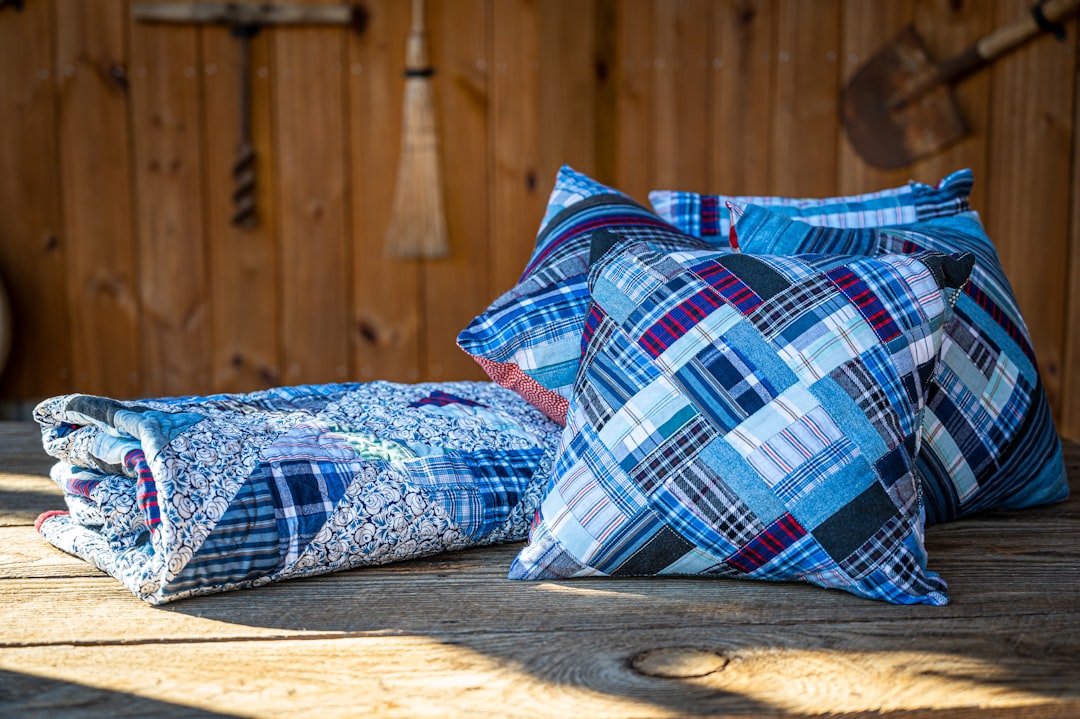 Blue patterned pillows and a quilt are shown.