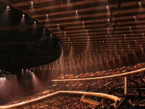 Arena with tiered seating and bright overhead lights