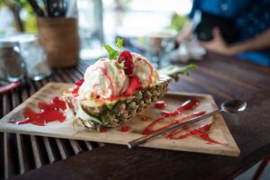 Ice cream with fruit served in a pineapple boat