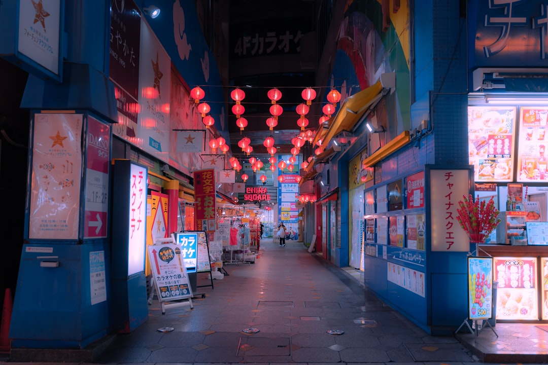 a narrow street with a lot of signs on it
