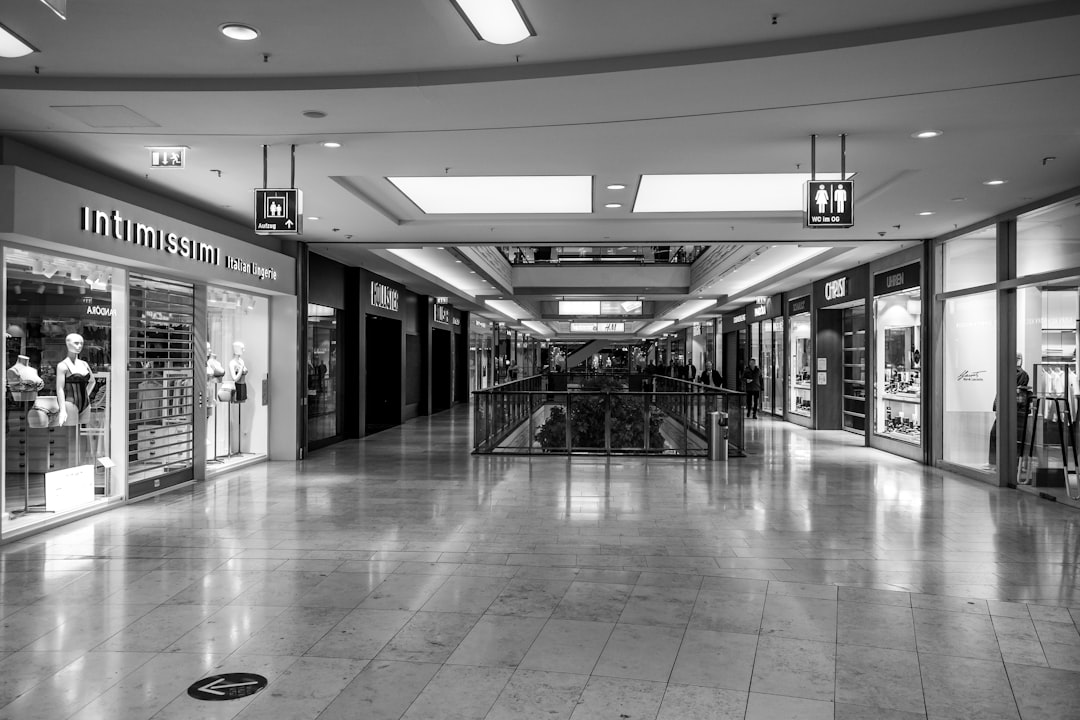 Empty shopping mall corridor with storefronts on sides