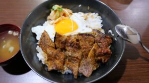 Bowl of rice with grilled meat and fried egg
